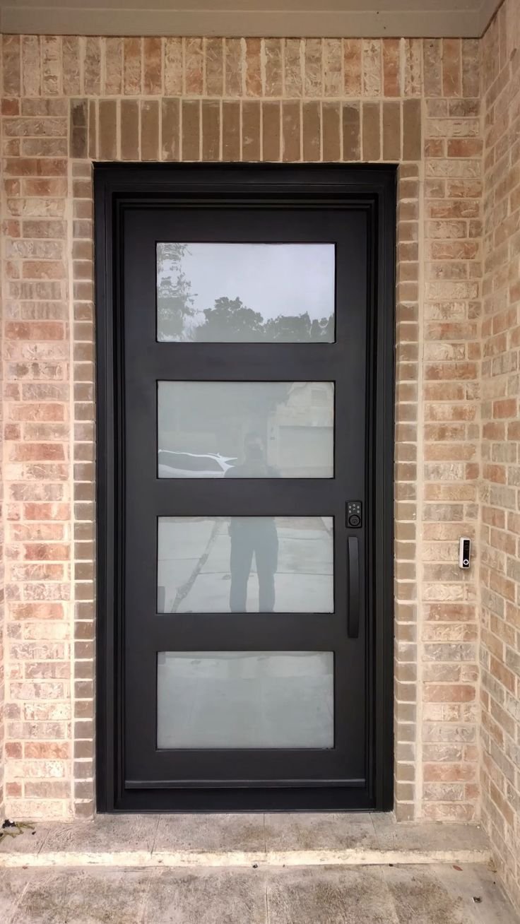 Modern black aluminum front door with vertical tempered glass inserts
